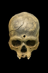 The human skull with hole isolated on black background