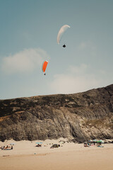 Fototapeta na wymiar Paragliding on the beach