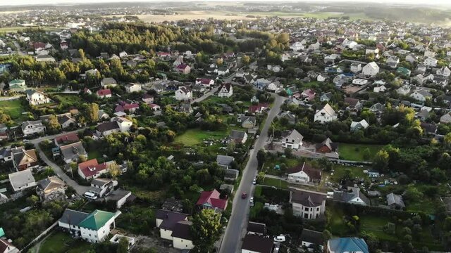 Aerial view on a residential area outside the city at sunset. Village drone photography.