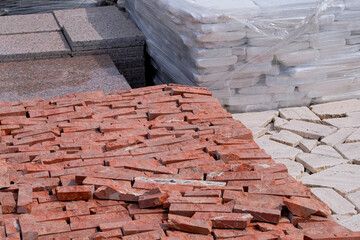 Tiles for decoration and design in construction. Construction Materials. Red stones are sold in...