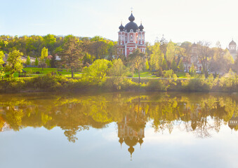 Church situated at the lake shore . Monastery Curchi from Moldova 