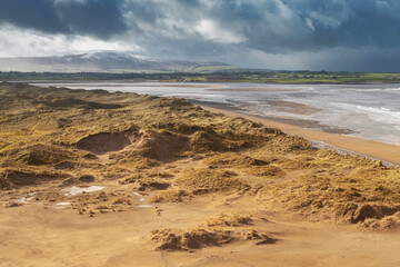 View on sandy dunes at Strandhill beach, county Sligo, Ireland., Dramatic cloudy sky. Nobody. Warm sunny day