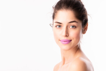 Headshot of beautiful woman wearing purple lipstic while posing at isolated white background