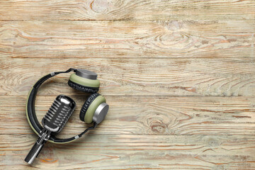 Headphones with microphone on wooden background