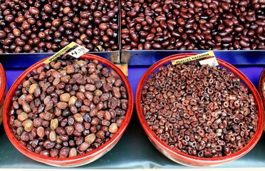 Greece, Athens, July 18 2020 - Stall with Throubes olives and Kalamata or Kalamon olives washers at street market.