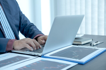 Trader businessmen analyze stock graph and report, set targets for online forex trading market management success