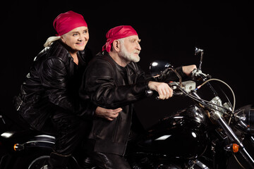 Fototapeta na wymiar Profile photo of aged bikers grey hair man lady couple drive vintage chopper traveling together feel young wear rocker leather jacket pants bandana isolated black color background