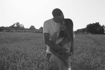
Man hugging pregnant woman black and white photo