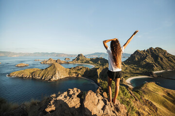 Woman with amazing view of Padar island in Komodo national park, Indonesia. Enjoying tropical...