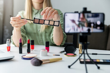 makeup beauty fashion blogger influencer recording video presenting cosmetics on social media at...