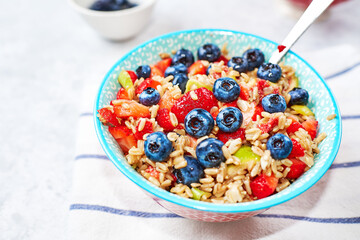 Healthy Homemade Oatmeal with strawberries, blueberries for Breakfast