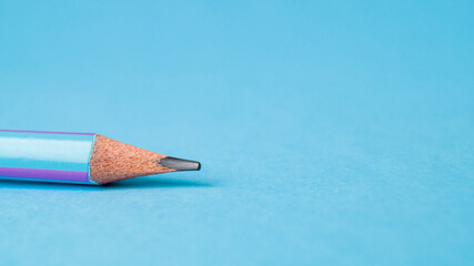Lead of blue pencil. Sharpened simple pencil on a blue background. Sharpened pencil tip. The concept of training, drawing, business. Copy space. Place for text.