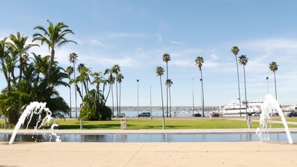 Fountain in waterfront city park near San Diego county civic center in downtown, California government authority, USA. Pacific ocean harbour, embarcadero in Gaslamp Quarter. Palms and grass near pier