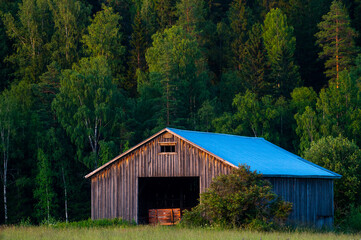 A beautiful rural closeup of an old and abandoned granary building in the middle of a field.
