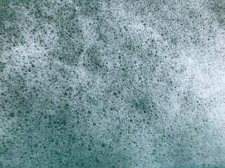 Many small bubbles cover all the blue water. Background.