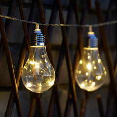 Bright yellow lights hanging in the night garden