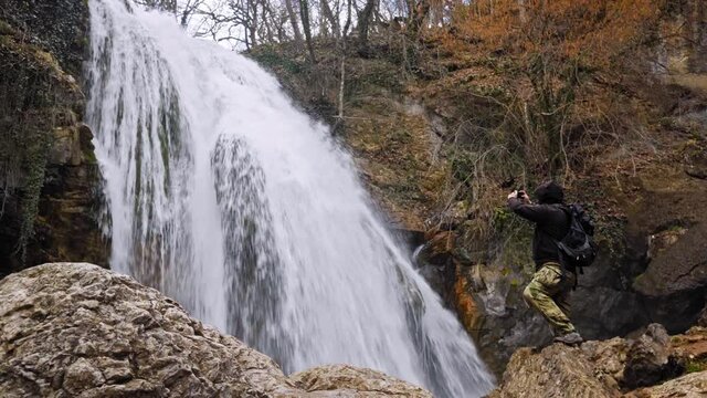 Cinemagraph Wonder Lust of man enjoying waterfall