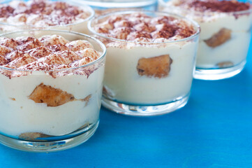 classic Italian dessert tiramisu in glasses, decorated with cocoa powder