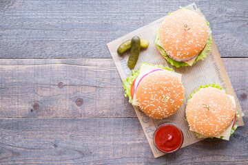 Top view group of burgers with sauce on the wooden background, copy space
