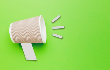 Takeaway coffee in shout concept on green background. Promotion or advertising sale.