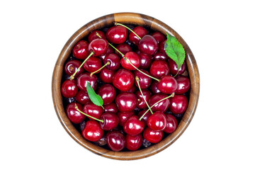 Top view of fresh juicy red sweet cherry berries in the wooden bowl isolated on white background in summer.