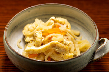Thinly sliced and dried strips of daikon simmered with fried tofu and sliced carrot