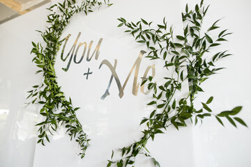 Wedding photozone with green grass and with two words. White photozone for bride and groom - Powered by Adobe
