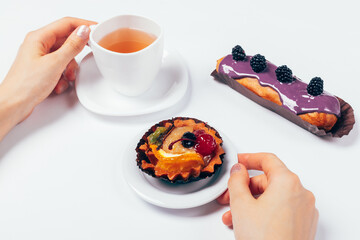Close-up of female hands holding cup of tea