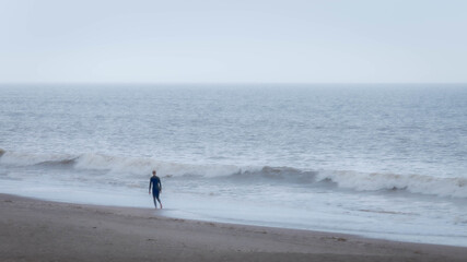 Fototapeta na wymiar man walking on the beach