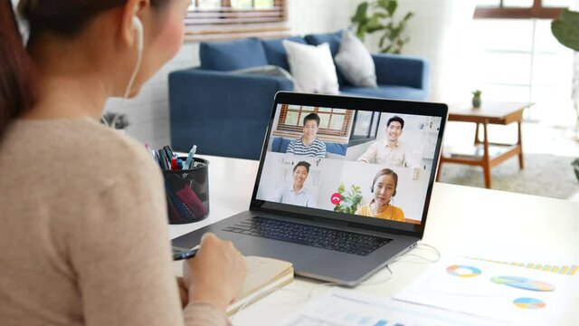 Young Asian businesswoman work at home and virtual video conference meeting with colleagues business people, online working, video call due to social distancing at home office