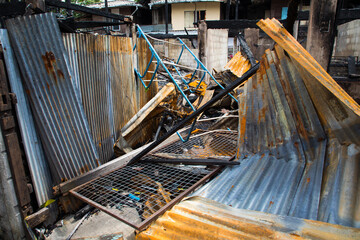 Burnt out house with charred roof trusses and burnt furniture
