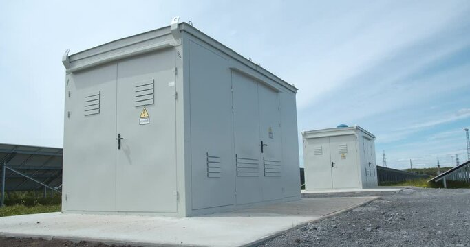 Two transformers near the solar panels at the solar power station, 4k