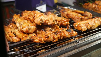 Meat kebabs frying on street. Set of yummy meat kebabs grilling on grating in traditional street cafe in Thailand.