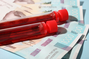 Test tubes with blood and money