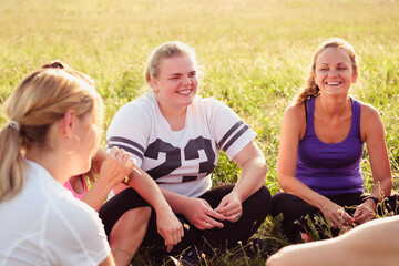 Group of female friends chatting in a spring field