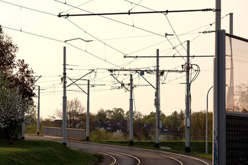 Tram rails and cables scenery. Tramway tracks and traction photo. Overhead electric wires and trail...