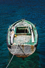 Old fishing boat on crystal clear water
