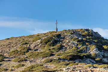 Fototapeta premium Cross on the pike of mountain in Spain, mountain Montseny