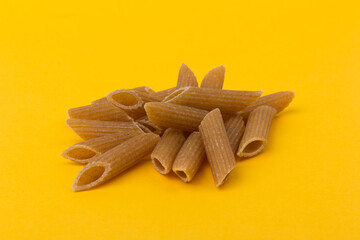 Pasta from hard wheat. Italian pasta on yellow background,  place for text.