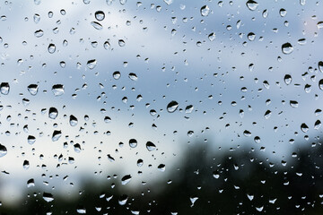 A small raindrop rests on the glass after rain.