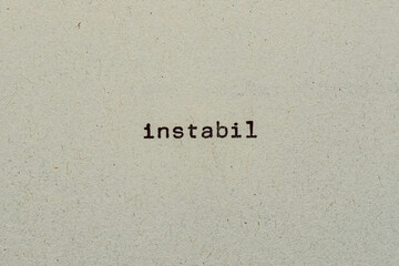 instabil als Text auf Papier mit Schreibmaschine