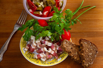 Homemade slices of salted bacon, lard, close-up. 
Sliced ​​lard, tomatoes, parsley, bread with nuts - a great appetizer. Food photography.