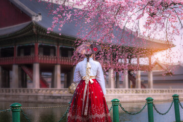 Cherry Blossom with Korean national dress at Gyeongbokgung Palace Seoul,South Korea. - obrazy, fototapety, plakaty