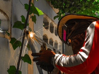 welder connects metal parts to complex structures using electric welding.Selective Focus