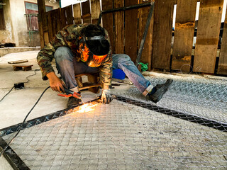 welder connects metal parts to complex structures using electric welding.Selective Focus