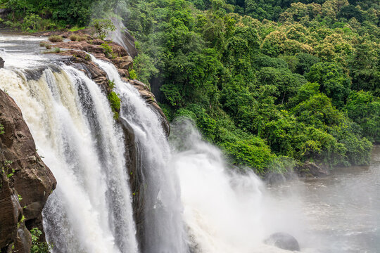 Beautiful nature view during Mansoon time with full filled water fall and green forest from the famous tourist place in Kerala, India called Athirappalli, Vaazhachaal