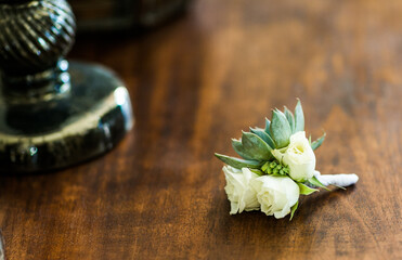 simple small white and green groom boutonniere with succulent