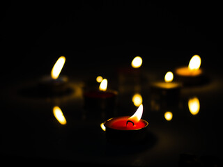 concept of mourning the dead from the corona virus represented by warm candles,COVID-19. Selective Focus