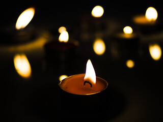 concept of mourning the dead from the corona virus represented by warm candles,COVID-19. Selective Focus
