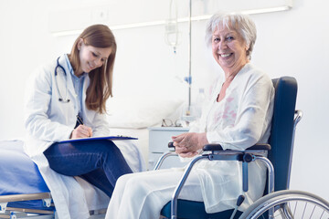 Nurse or doctor writing patient notes in a ward